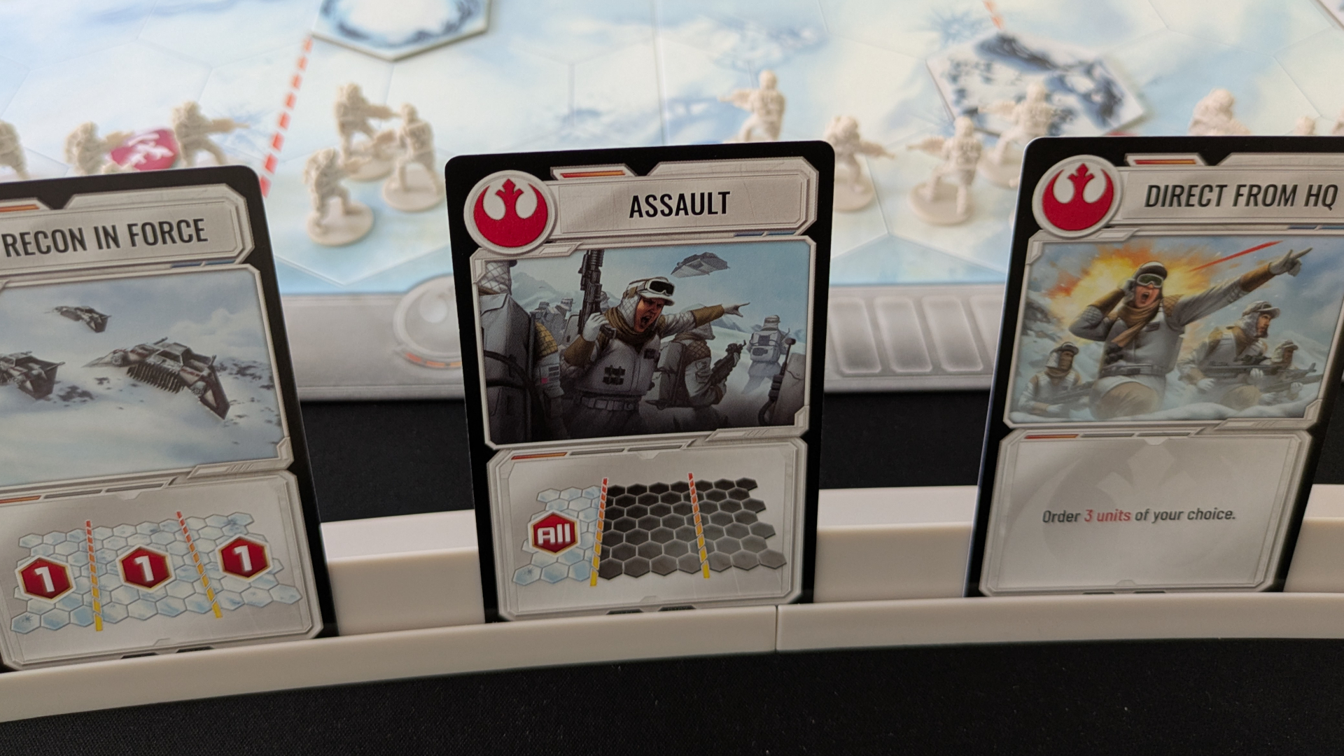 Star Wars Battle of Hoth cards in front of a board full of miniatures