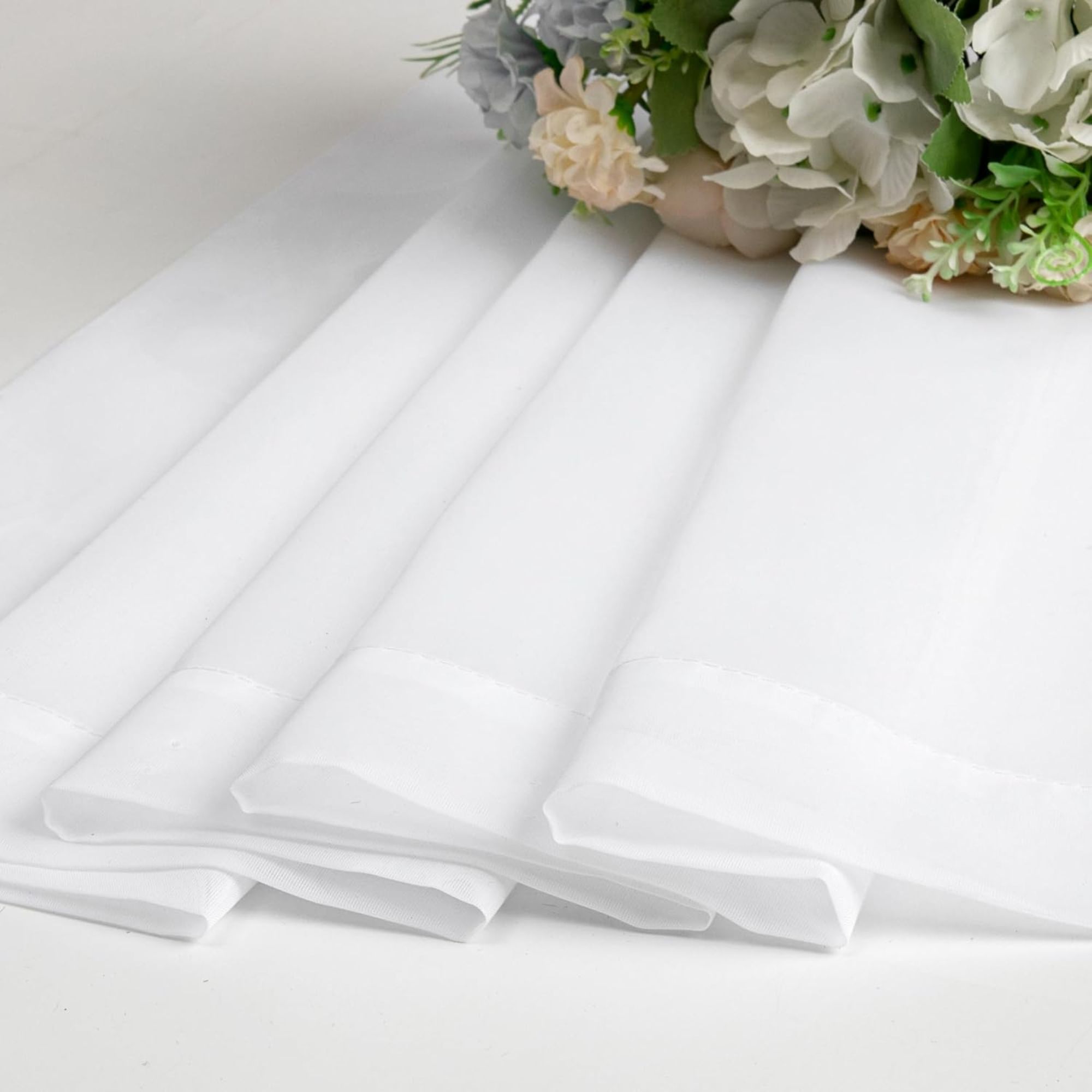 Folded sheer white curtains