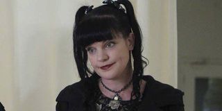 Pauley Perrette looking a bit somber as she stands on NCIS, wearing all black.