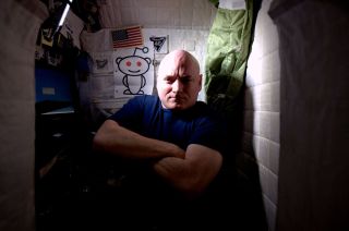 NASA astronaut Scott Kelly is photographed inside his crew quarters, where he has spent almost half of his yearlong stay on the International Space Station.