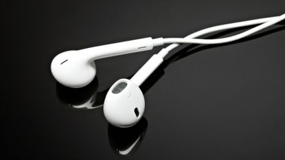 Apple EarPods on black background