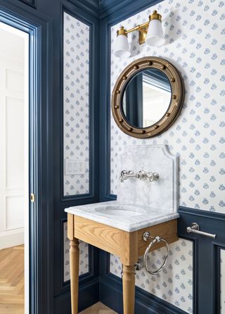 blue and white decor in a powder room with a tiny vanity