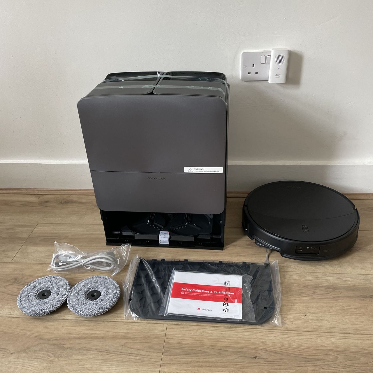 Roborock Saros 20 Robot Vacuum components laid out on wood-effect flooring