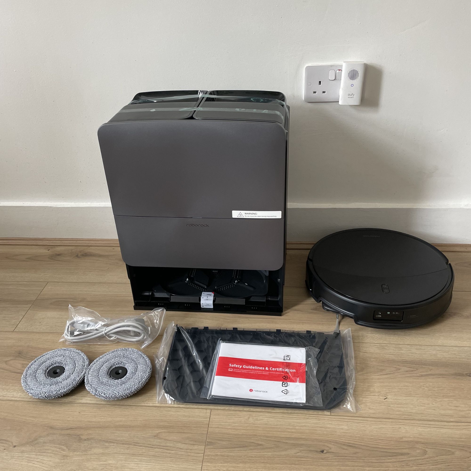 Roborock Saros 20 Robot Vacuum components laid out on wood-effect flooring