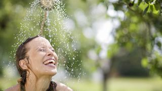 Close up of a woman enjoying an outdoor shower