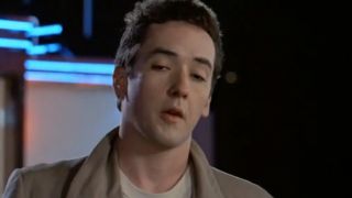 John Cusack as Lloyd Dobler looking skeptical in Say Anything