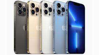 A line up of iPhone 13 smartphones in various colors.