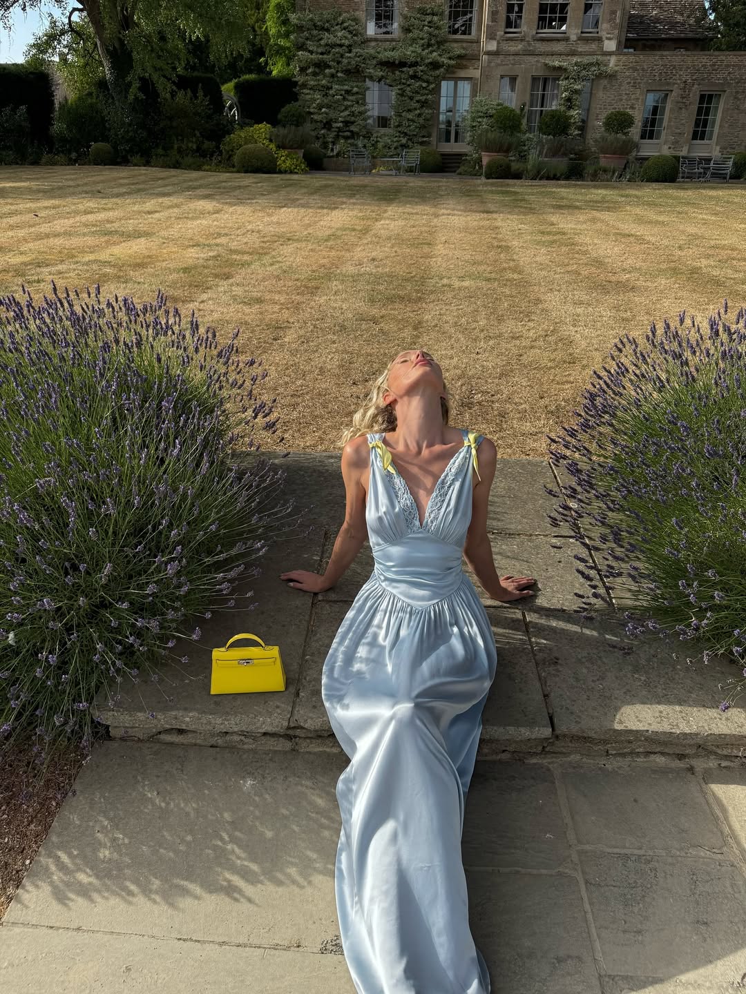 @Hoskelsa in a light blue satin dress with yellow handbag