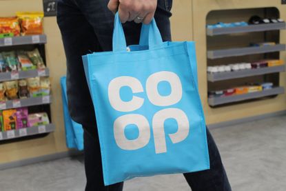 Person carrying Co-op shopping bags