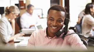 Man in office on a phone call