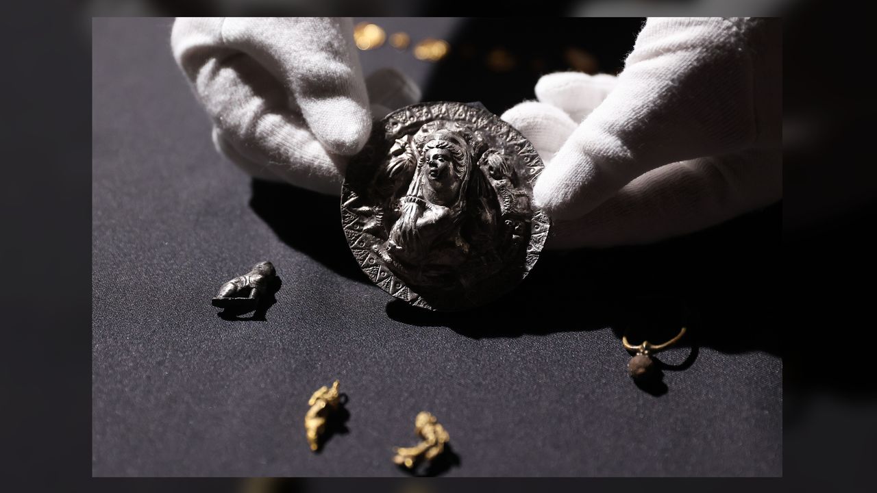 The silver medallion from the first century B.C. was worn on the chest of the woman it was buried with.