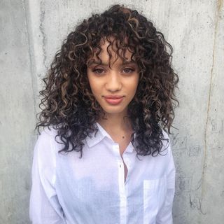 Woman with curly brunette hair