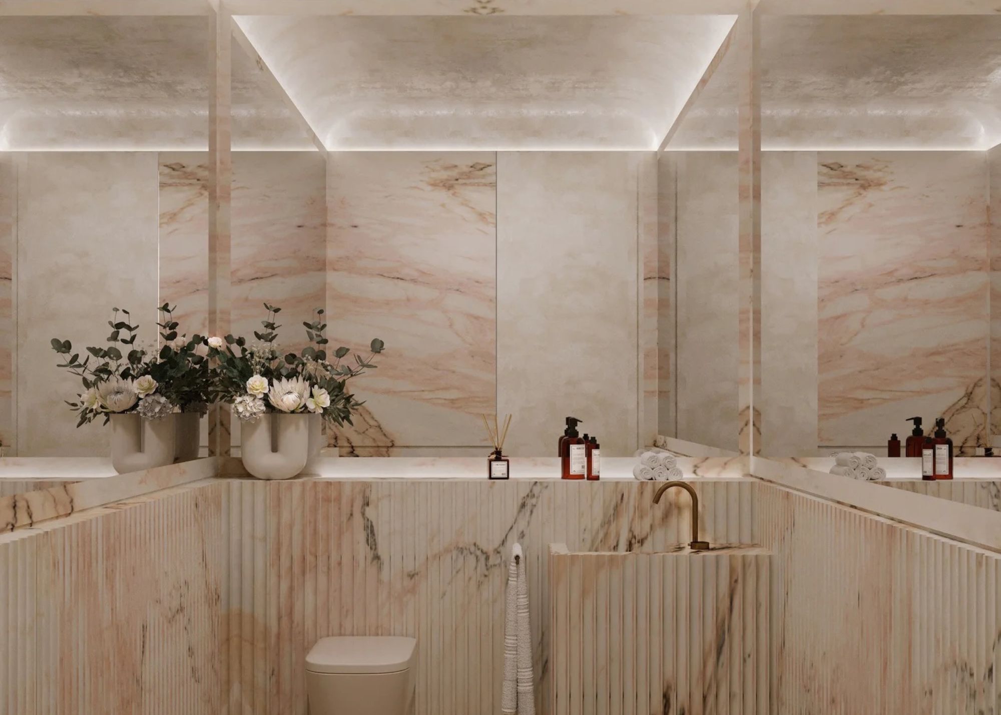 A bathroom designed in pink marble with recessed lighting
