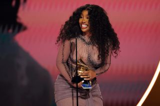 SZA accepts the "Best R&B Song" award for "Snooze" onstage during the 66th GRAMMY Awards.