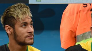 Brazil's injured forward Neymar sits on the bench during the third place play-off football match between Brazil and Netherlands during the 2014 FIFA World Cup at the National Stadium in Brasilia on July 12, 2014. AFP PHOTO / VANDERLEI ALMEIDA (Photo credit should read VANDERLEI ALMEIDA/AFP via Getty Images)