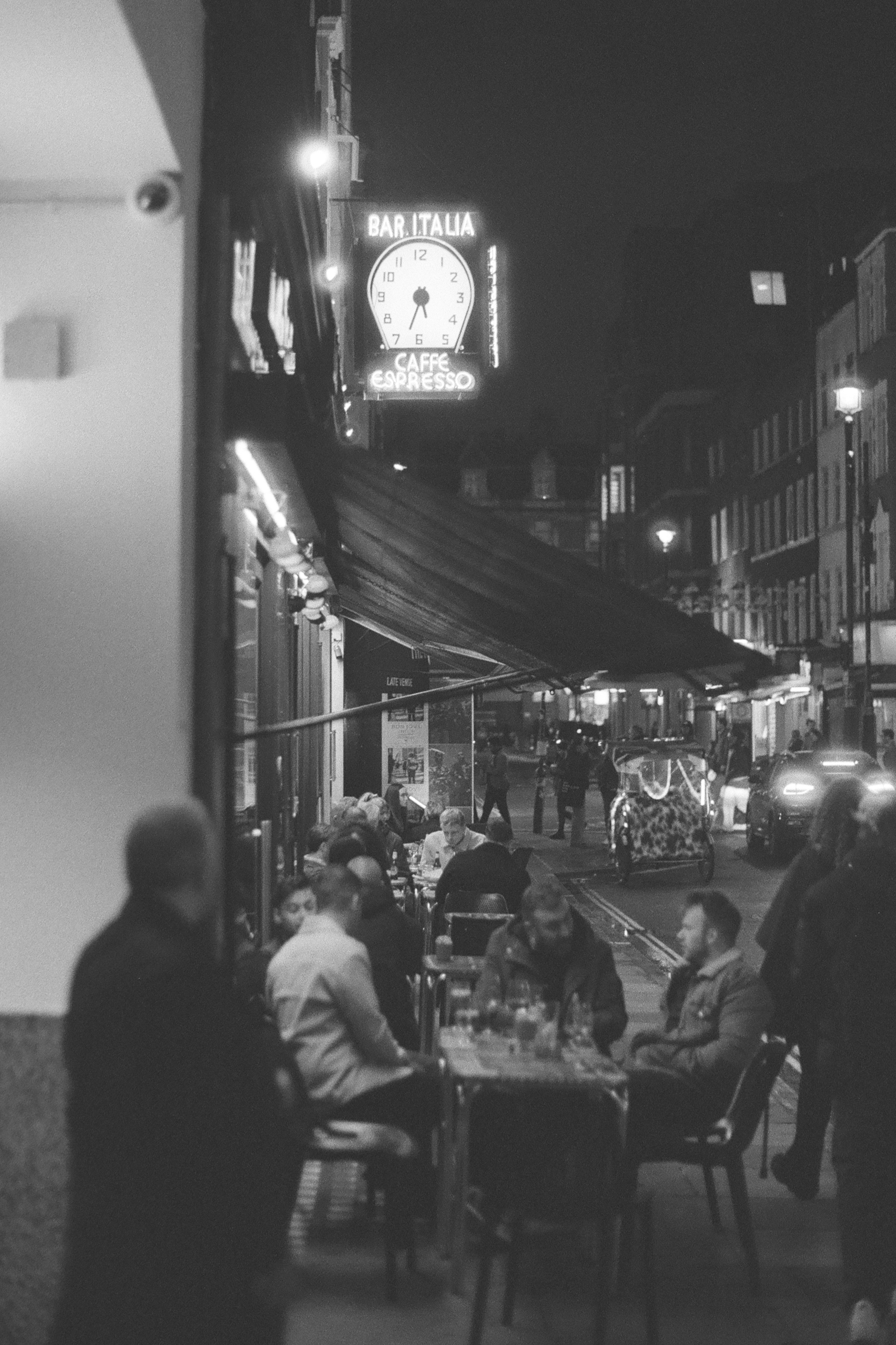 Sample photo of AgfaPhoto APX 400 35mm film showing night-time scene outside Bar Italia cafe in Soho, London