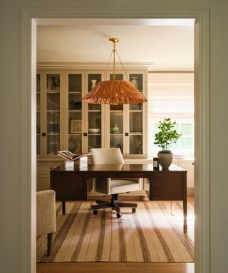 home office with striped rug and dark desk