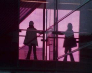 Silhouette of two people with purple background