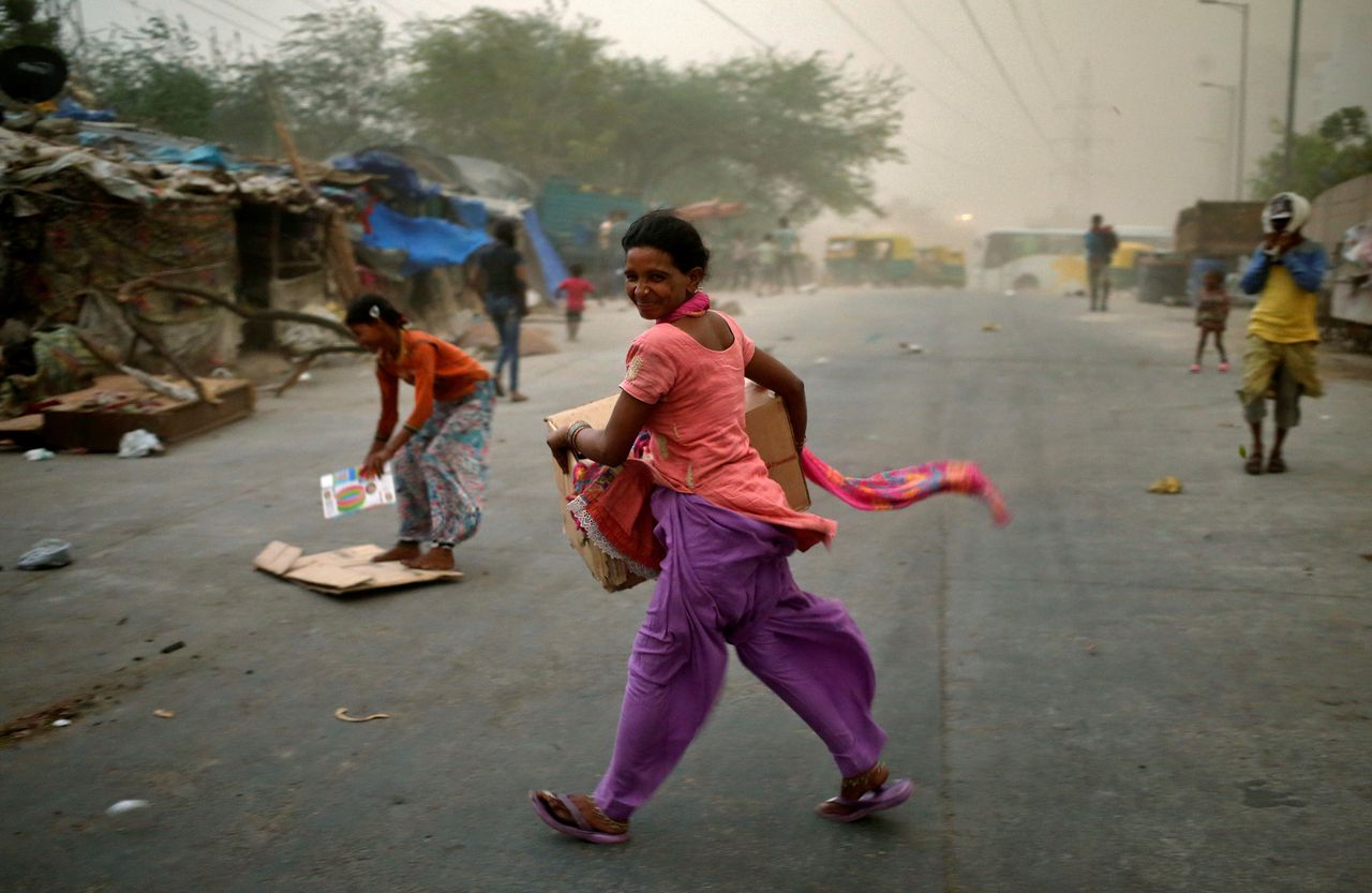 A woman is caught in a dust storm.