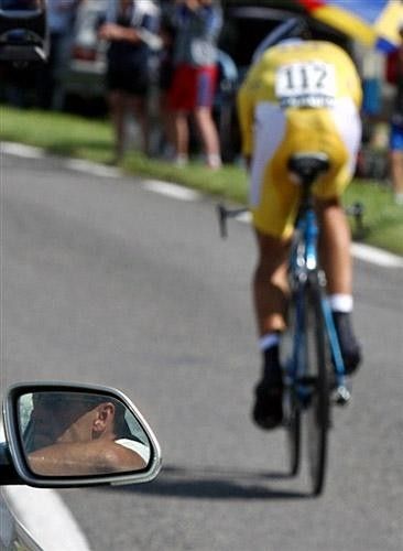 Going forward, looking back: Armstrong watches Contador heading toward possible Tour glory.