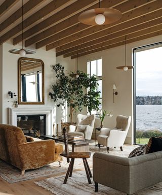 living space overlooking water with sofa, chairs and coffeet table