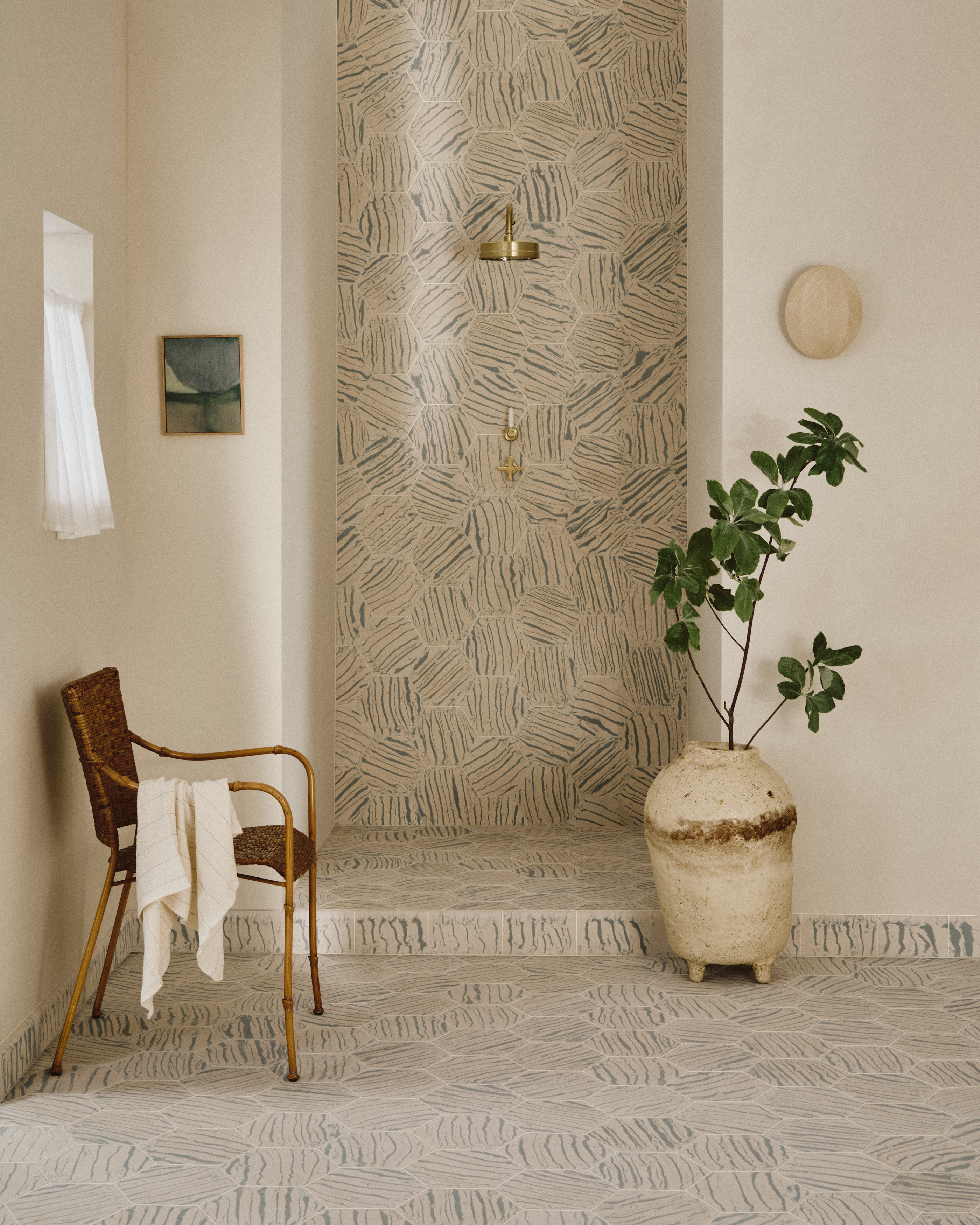 A bathroom with patterned tiles in hexagon shape