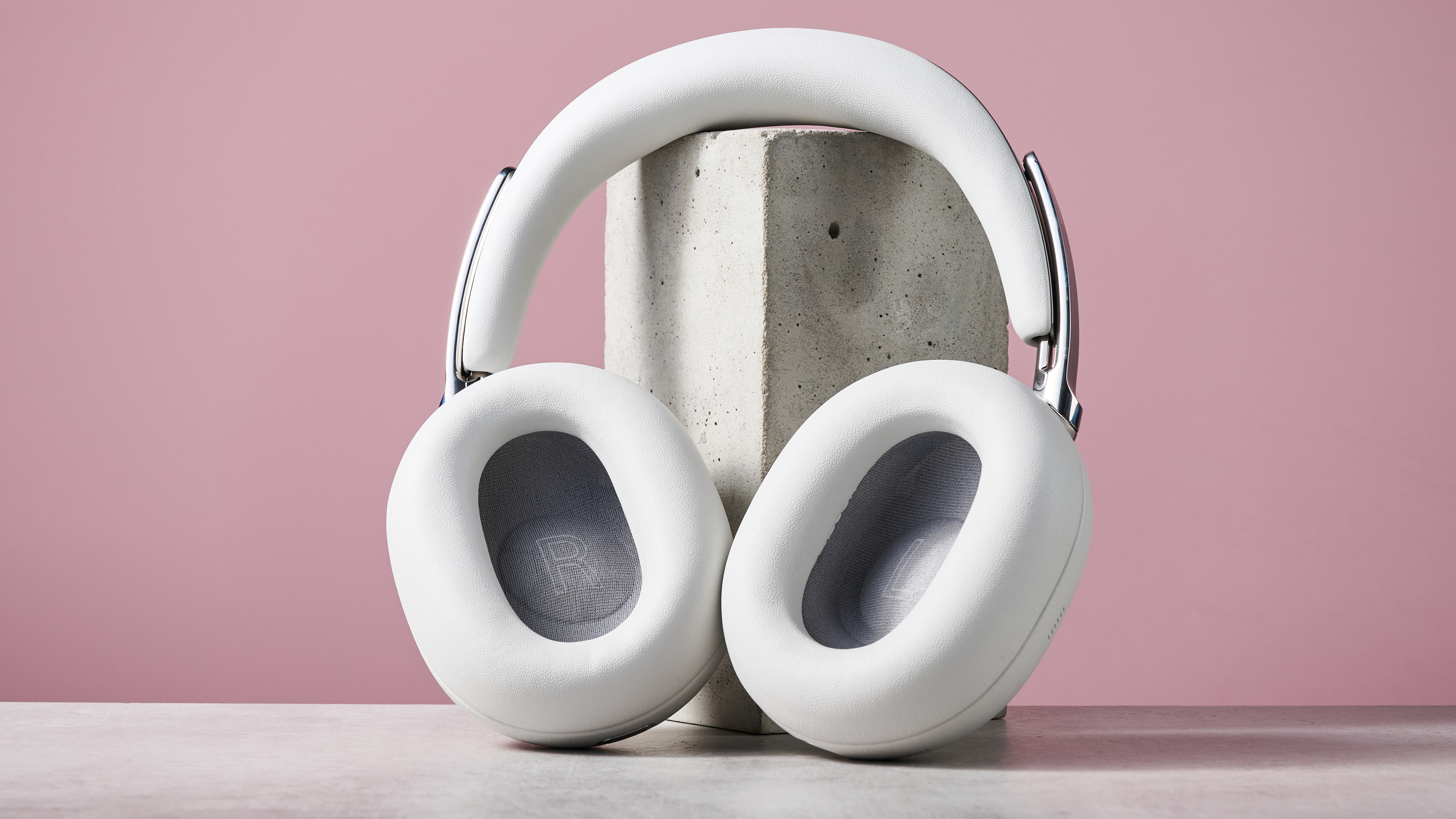 Sony 1000X The Collexion headphones leaning against a stone block showing the large size of the earpads