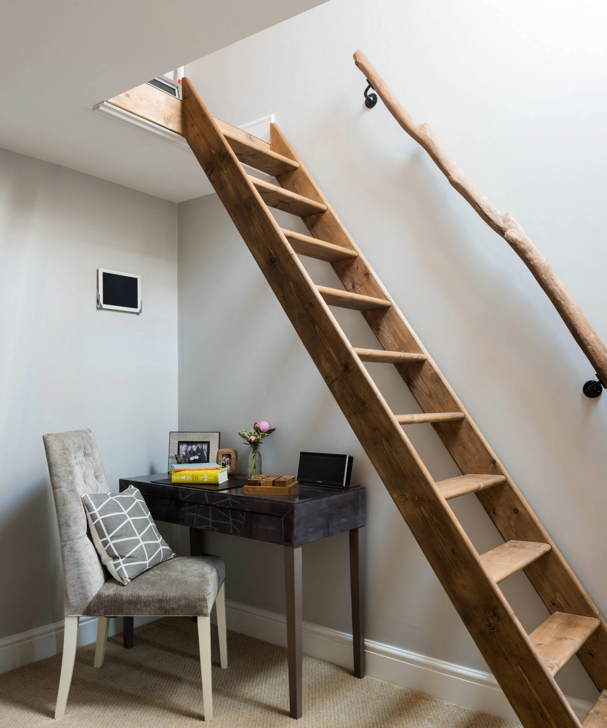 Study area with a wooden fixed type of loft ladder leading up to the attic
