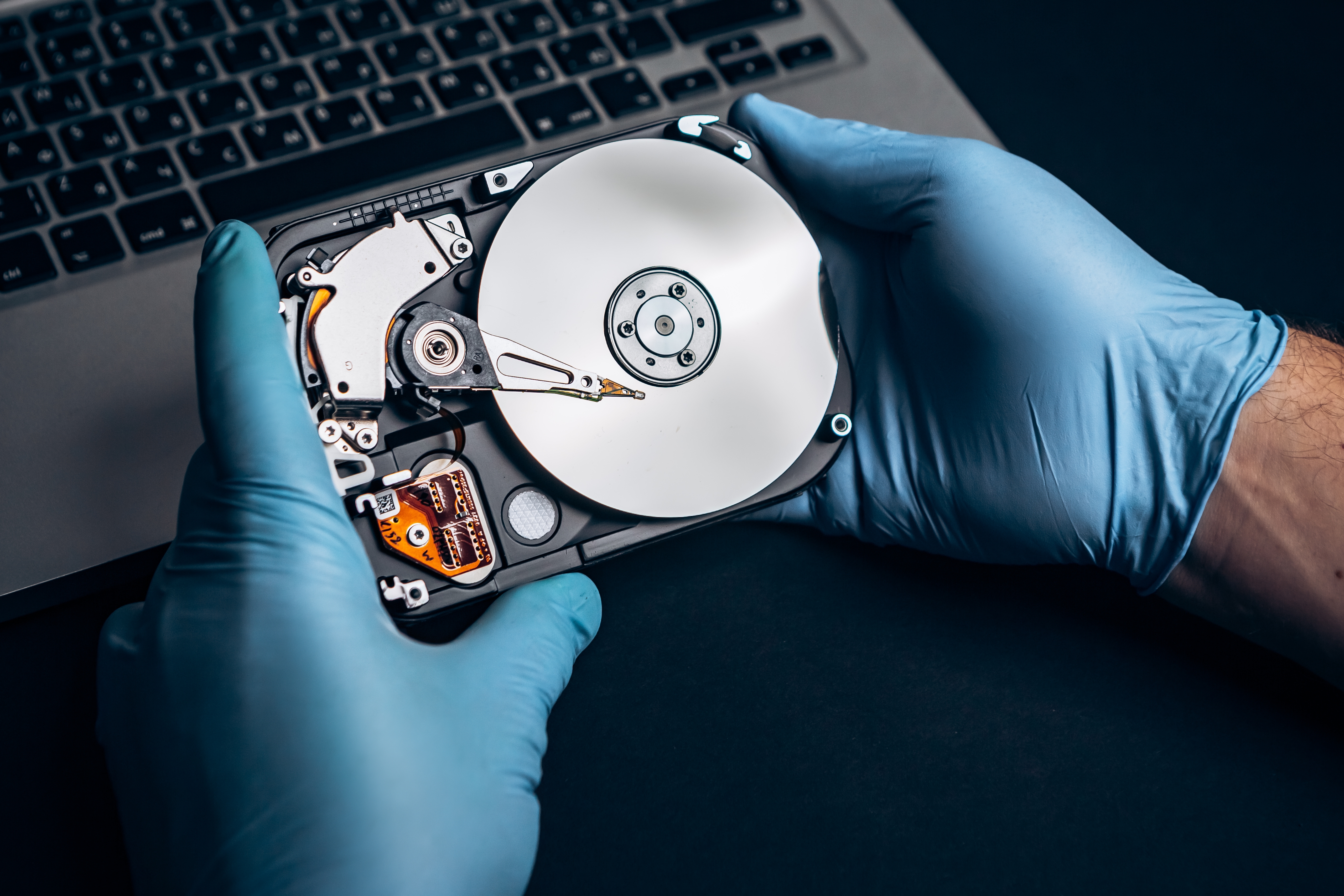 Computer service engineer technician workplace repairing fixing disassembled HDD hard drive data disc SSD, backup part of PC or laptop. Recovery, maintenance work, access file. Profession repairman