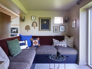 built-in banquette seat in living room with checkered upholstery and assorted throw pillows