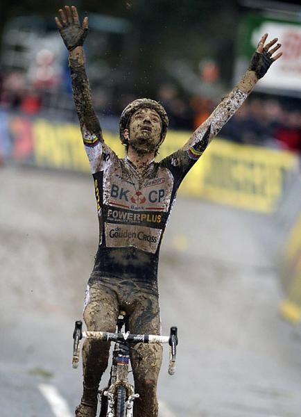 Winner Niels Albert managed to wipe some of the grime off of his chest to showcase his sponsors at .the finish line.