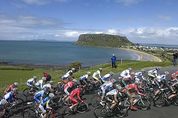 The peloton at the top of the climb with the 'Nut' and Stanley township in the background.
