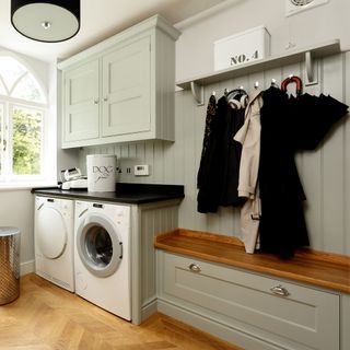 White walls with wooden flooring and washing machine