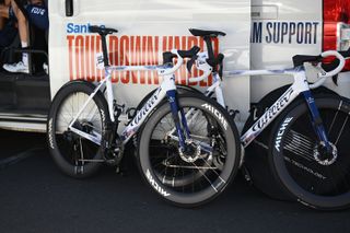 Two Groupama FDJ Wilier bike with Miche wheels leaning against a van