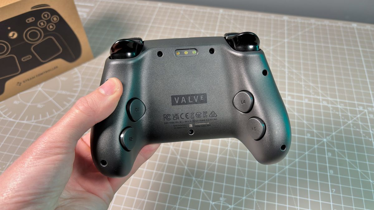 The Steam Controller on a desk during a teardown, with various parts removed.