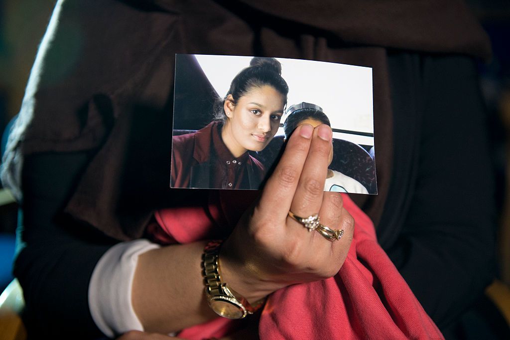 Shamima Begum&amp;#039;s sister holds a photo of Begum.