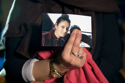 Shamima Begum's sister holds a photo of Begum.