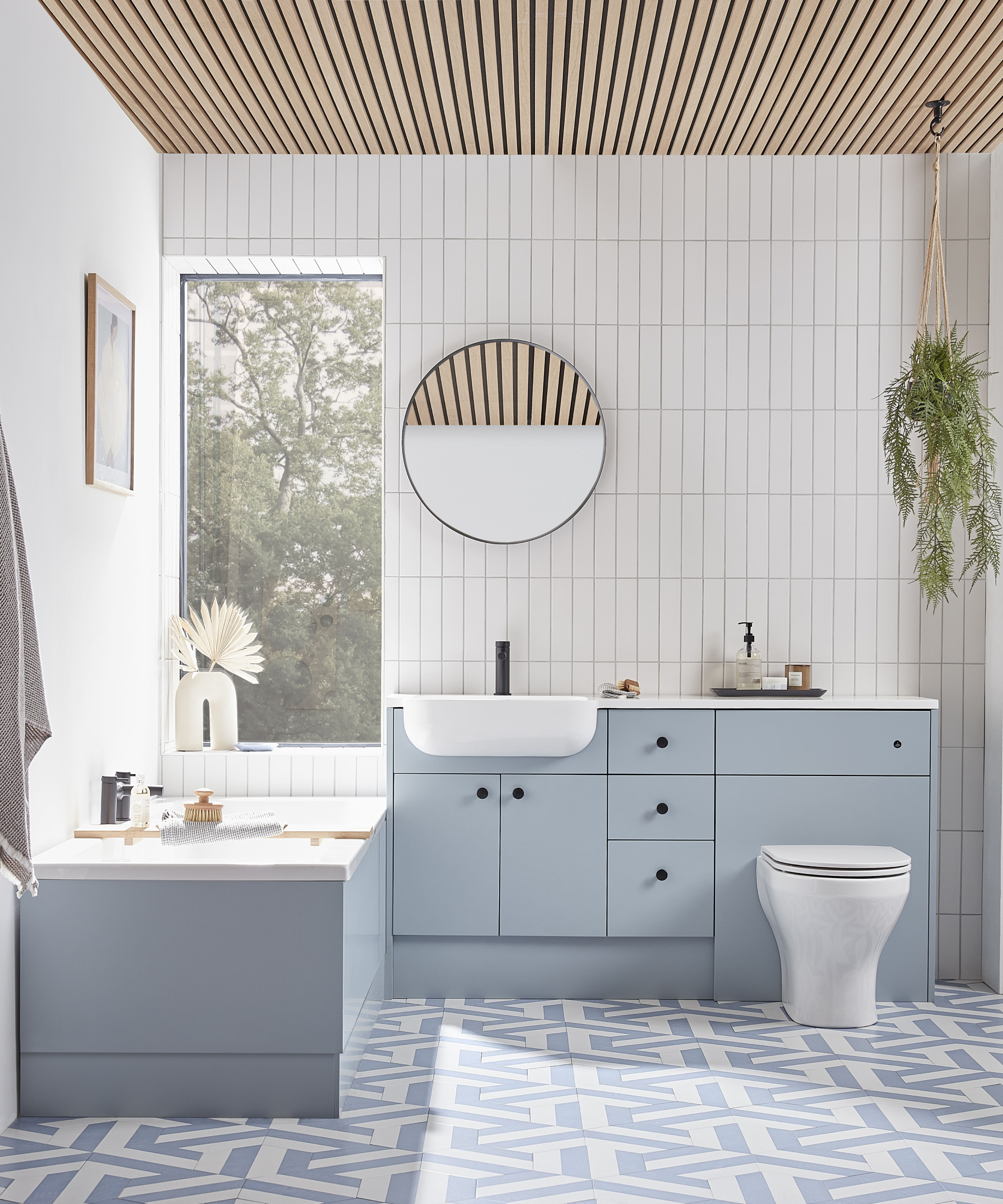 bathroom with pale blue fitted furniture and narrow wooden slats on ceiling