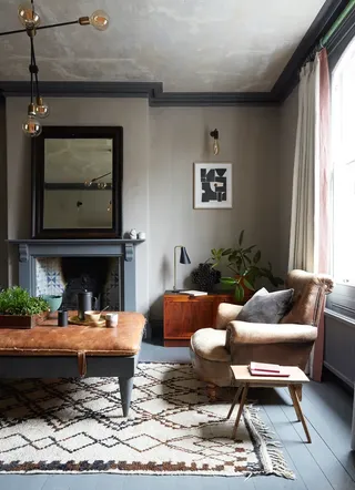 A living room with gray floors and beige walls