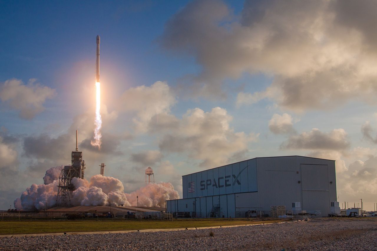 This view of the NROL-76 spy satellite shows SpaceX's horizontal integration facility (foreground) as the Falcon 9 launches into space from Pad 39-A at NASA's Kennedy Space Flight Center on May 1, 2017.
