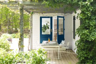 Decked area with a pergola and planting