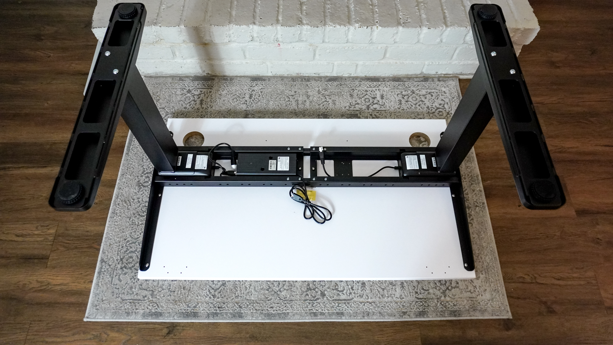 Assembling the Uplift V3 standing desk on top of a carpet