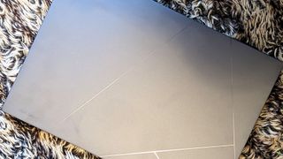 Asus Zenbook 14X OLED laptop on carpet