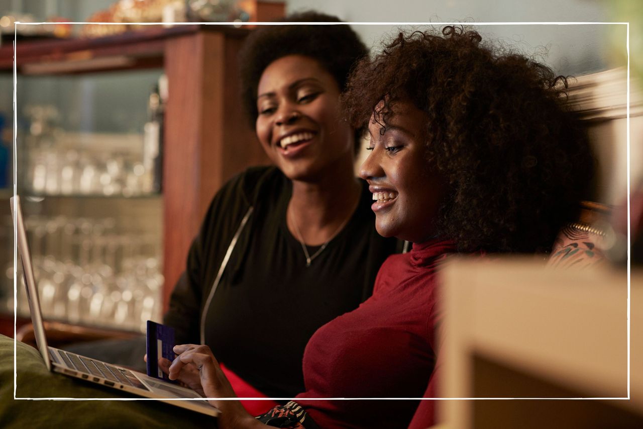 smiling women looking at a laptop at home