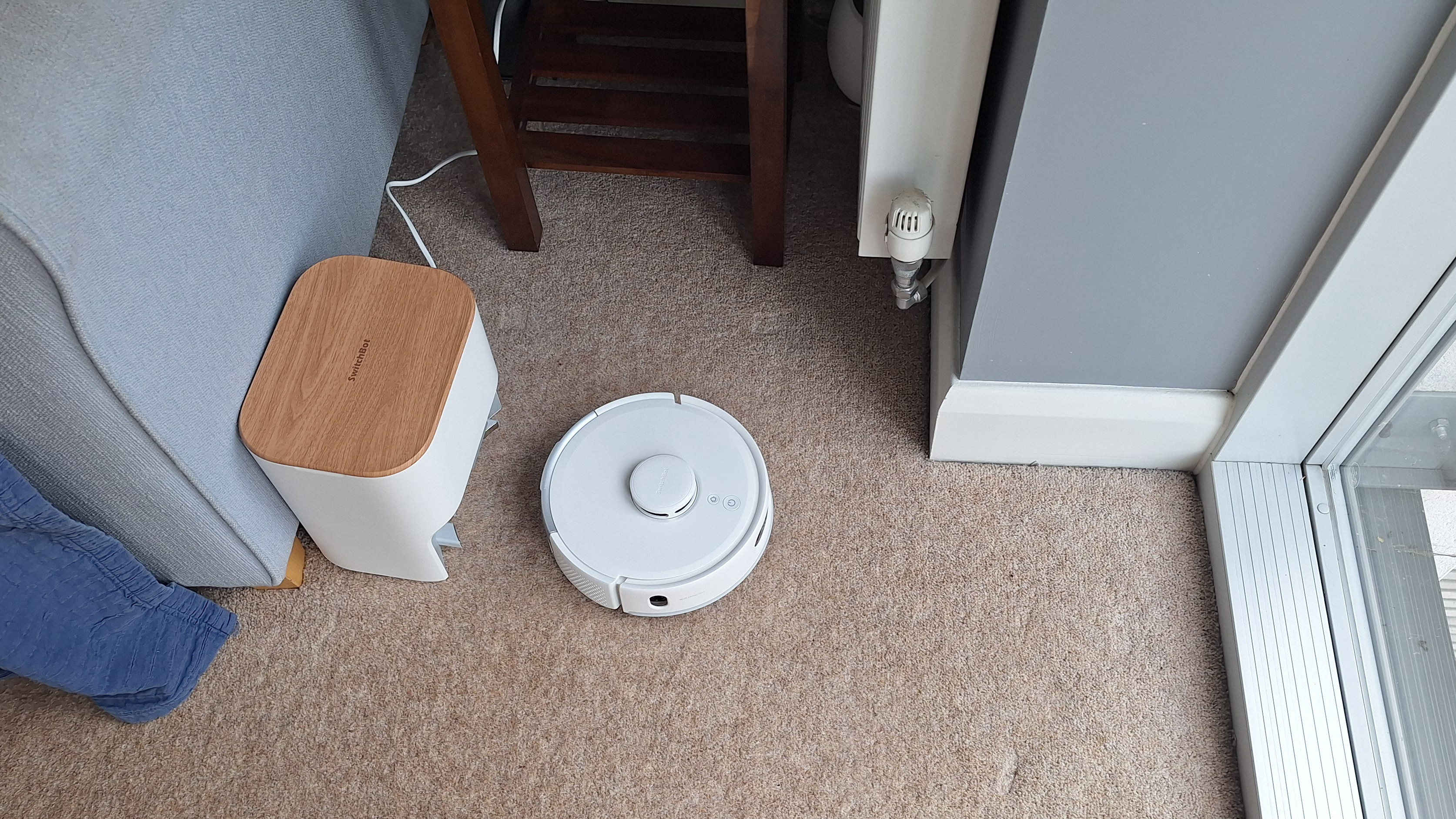 SwitchBot K11+ robot vacuum driving away from its dock