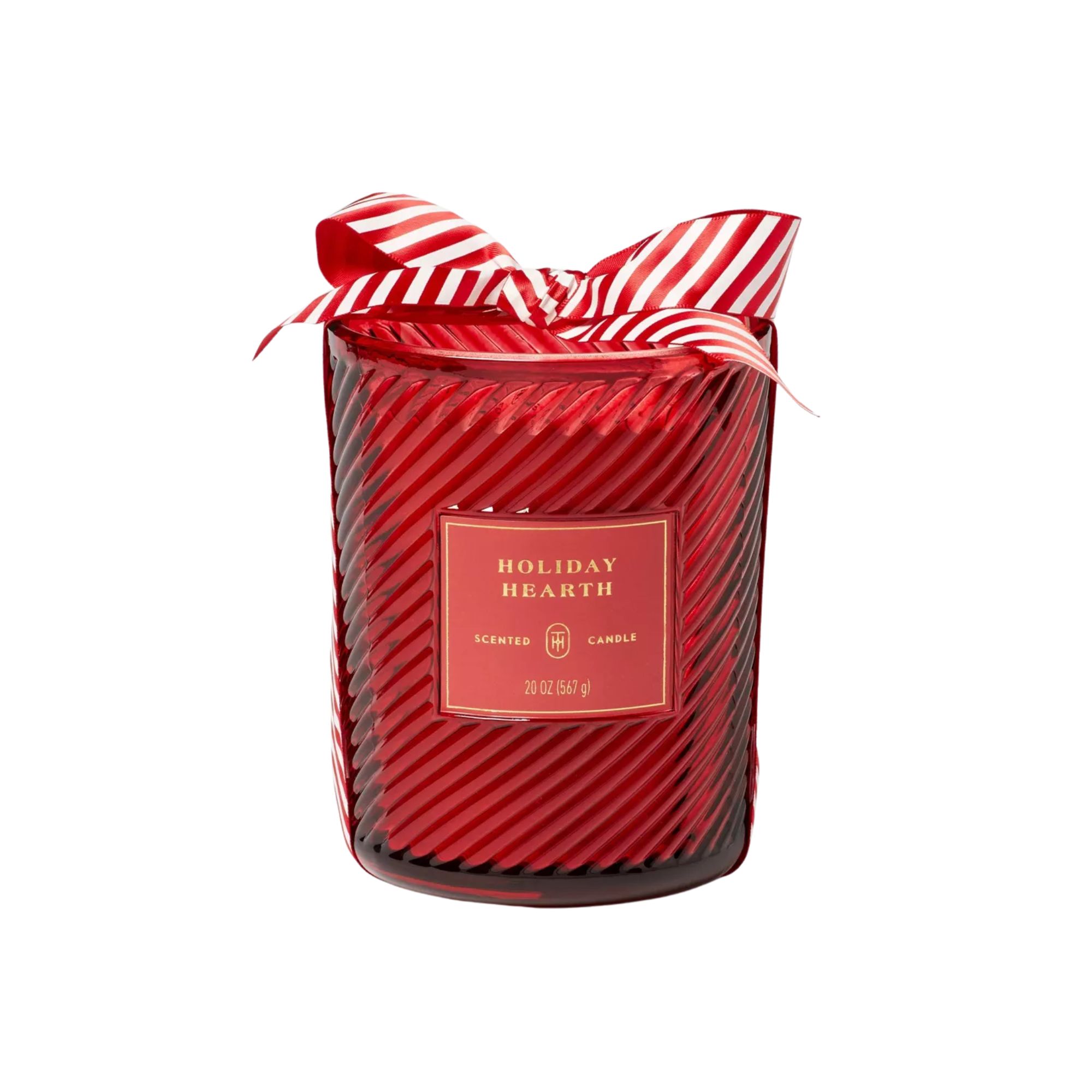 A candle in a red glass swirled jar, with a red and white striped bow on top of it