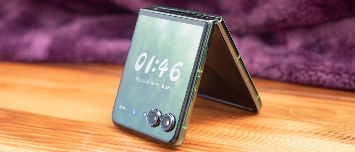 Motorola Razr Plus 2024 in green standing like a tent with a clock on its face