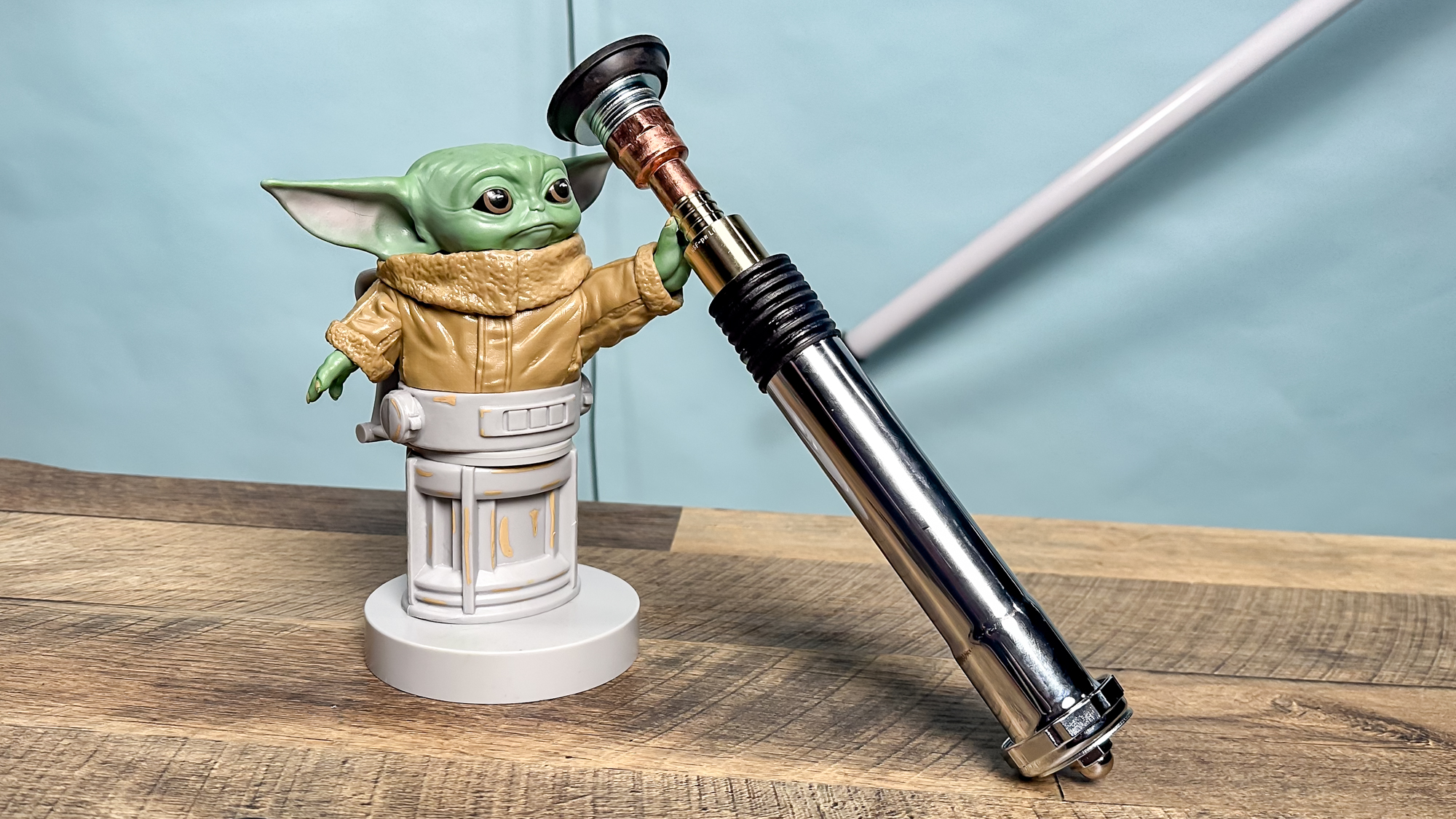 Grogu model holding homemade lightsaber