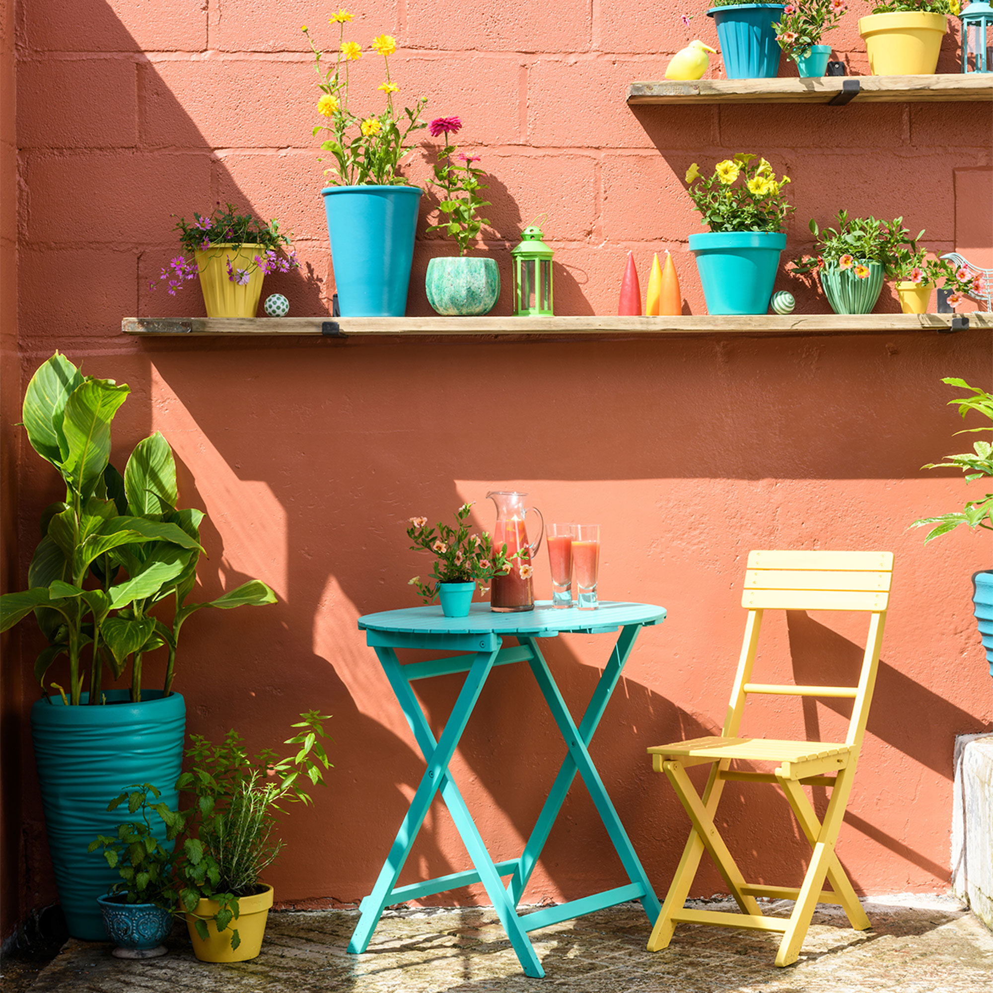 outdoor wall painted orange with shelves and planters