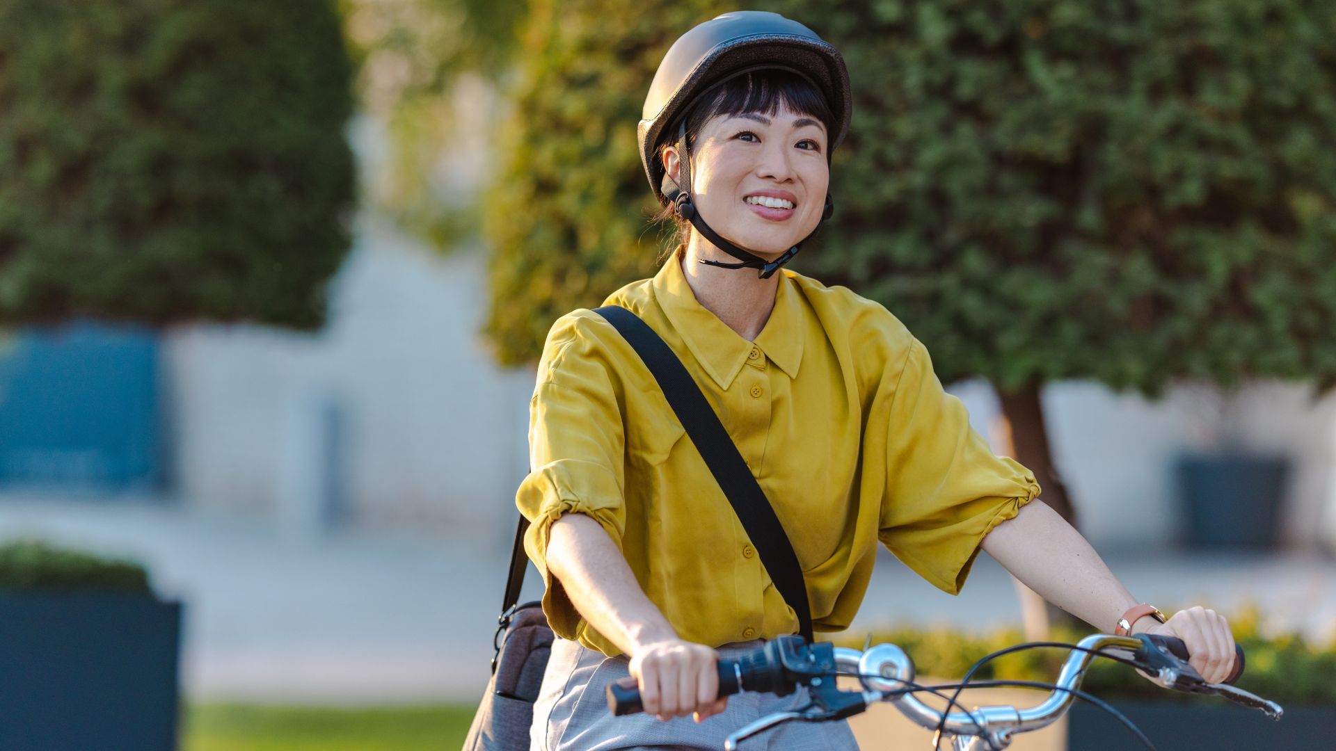 Woman riding bike along a road